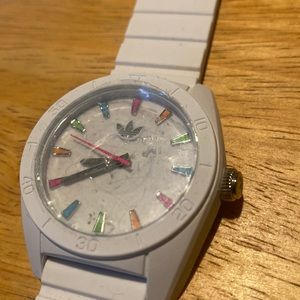 Adidas analog watch. White silicone band and case. Colorful rainbow accents.